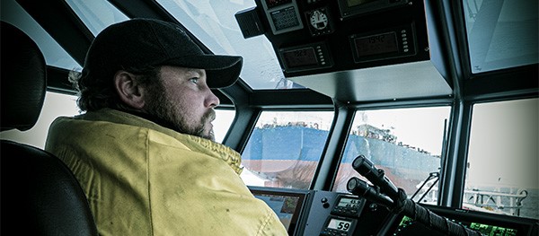 Photo of a captain at the helm